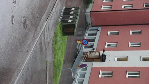 Heavy rain and thunderstorm over a street with residential buildings Stock Footage 338230044