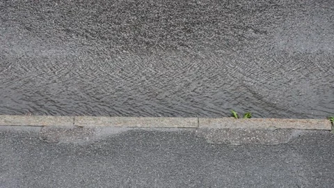 Heavy rain and thunderstorm over an asphalt road Stock Footage 338230053