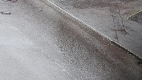 Heavy rain and thunderstorm over an asphalt road Stock Footage 338230428