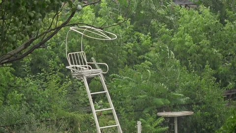 Heavy rain and wind on an abandoned tennis court, overgrown with plants Stock Footage 92201343