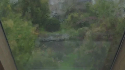 Heavy Rain On Attic Window With Blurry Background Stock Footage 249874806