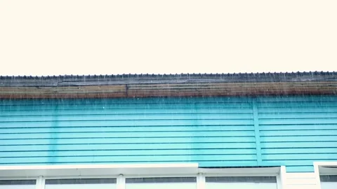 Heavy rain on the background of gray clouds. Heavy rain pours from the roof of Stock Footage 233008317