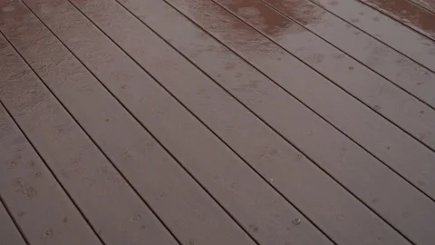 Heavy rain on brown composite outdoor floor with wood pattern Stock Footage 155506300