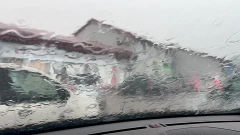Heavy Rain On Car Windshield During Stormy Weather In City Traffic Video stock 341415602
