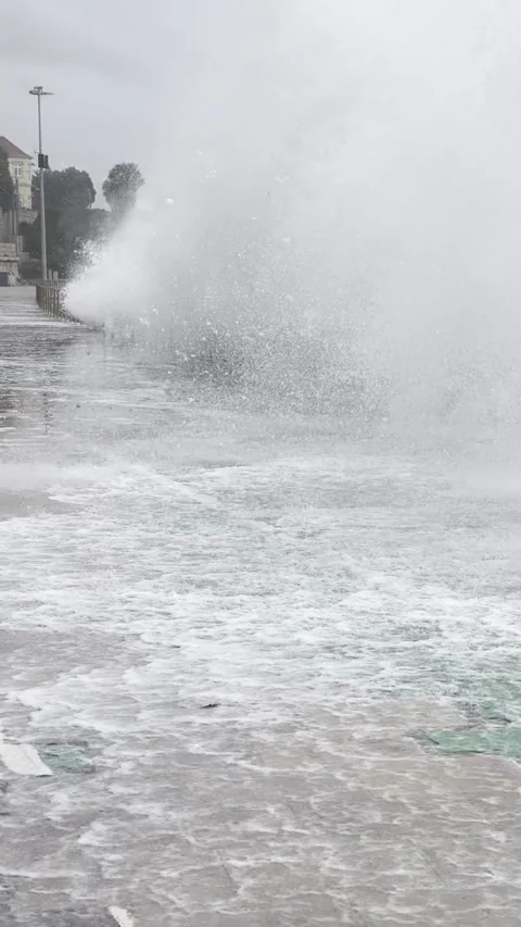 Heavy rain causes flooding on waterfront promenade in Cascais, Portugal Stock Footage 304877291