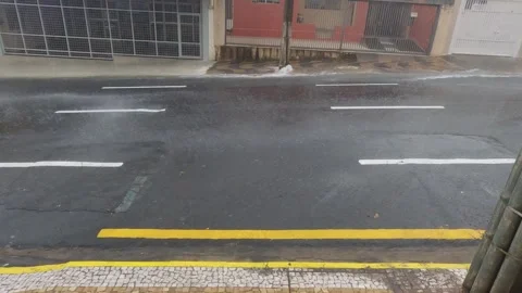 Heavy rain causes a strong flash flood on an asphalt street in Brazil 스톡 동영상 328485207