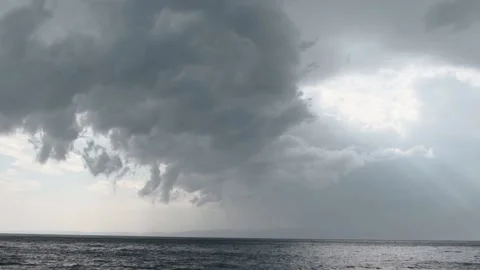 Heavy rain clouds over the calm sea -Storm coming -Slowmo Panning Stock Footage 166214926
