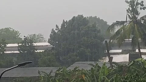 Heavy Rain Distant View Over Rooftops Tropical Village Storm in Philippines Stock Footage 346310395