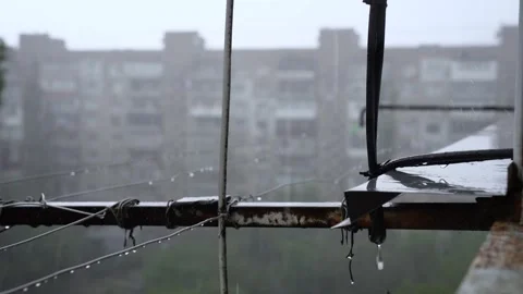 Heavy Rain Dripping from Old Rusty Balcony Window Cornice and Clothesline Ropes Vídeo Stock 335583877
