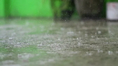 Heavy Rain Drops Splashing on Wet Concrete Floor Close Up. Video stock 337734086