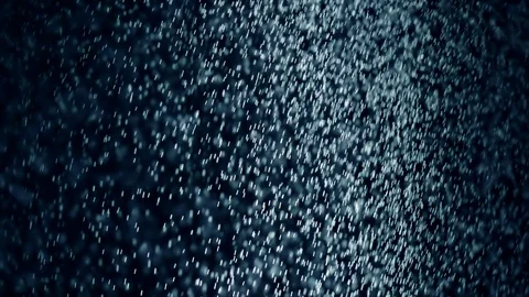 Heavy rain falling against dark sky background in extreme slow motion Video stock 124210629