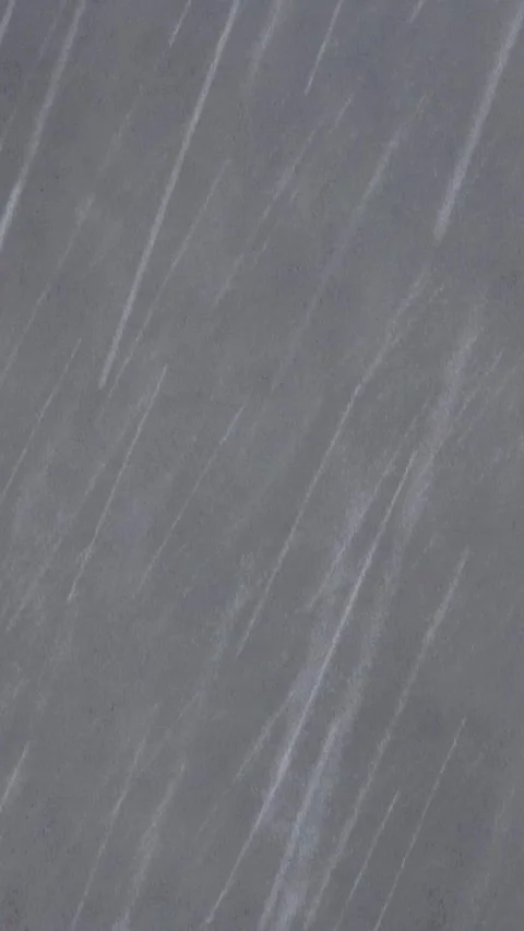Heavy rain falling against a dark background with authentic rain sounds. 4K Stock Footage 337805445