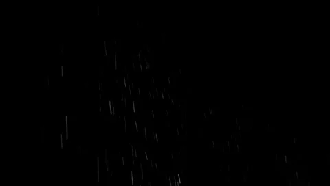Heavy rain falling against a dark night sky black background Stock Footage 346559388