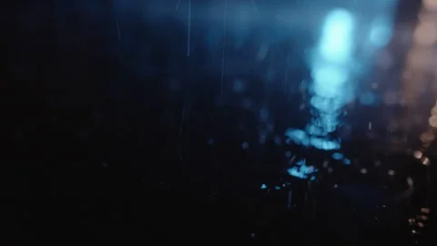 Heavy Rain Falling and Splashing at Night Lit by Cold Blue Light, Slow Motion Stock Footage 346076701
