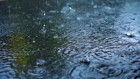 Heavy rain falling on asphalt creating ripples and splashes on a dark wet s.. Stock Footage 326134106