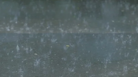 Heavy rain falling asphalt raindrops splashing Stock Footage 110886094