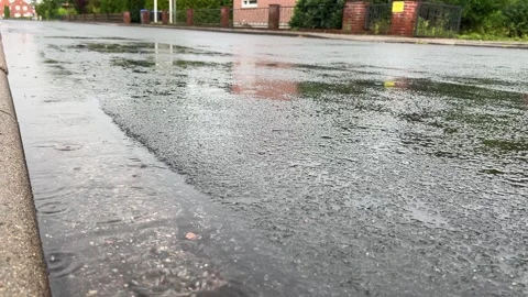 Heavy Rain Falling on Asphalt Road and Covering Surface with Water Stock Footage 340214121