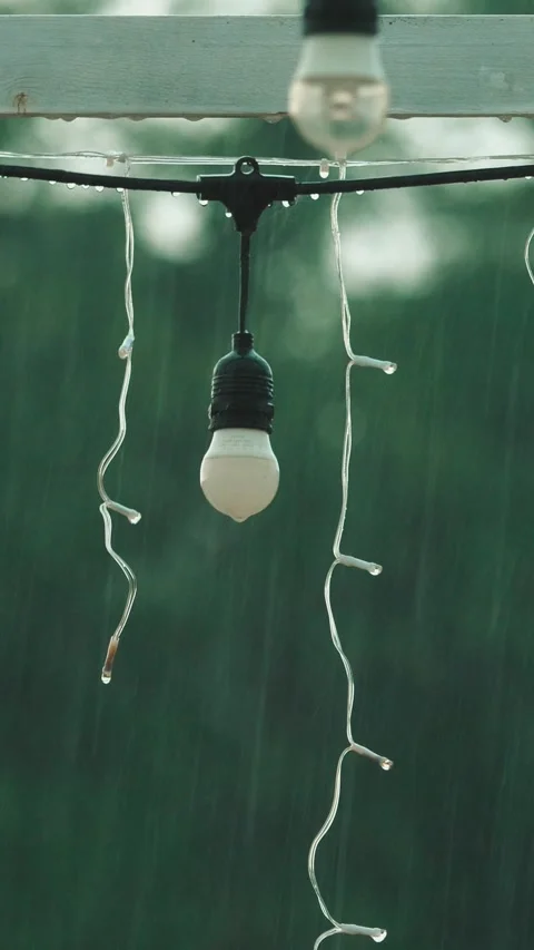 Heavy rain falling behind unlit garden gazebo Stock Footage 309835090