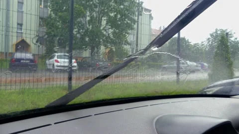 Heavy rain falling on the car windscreen Stock Footage 133737172
