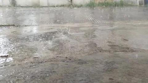 Heavy Rain Falling on Concrete Ground – Close-Up Splashing Water Stock Footage 308817285