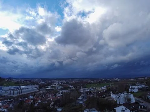 Heavy rain falling from dark cloudy sky in germany. Small village in rainy day. Foto stock
