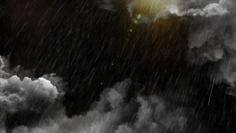Heavy rain falling from dark storm clouds with a subtle sun flare in the night Stock Footage 345634771