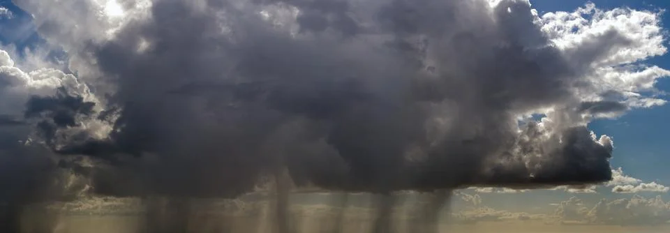 Heavy rain falling down from stormy clouds during thunderstorm on dark sky 写真素材