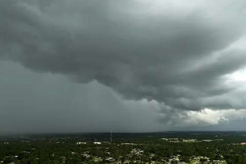 Heavy rain falling down from stormy clouds over rural Florida suburbs Stockfoto's