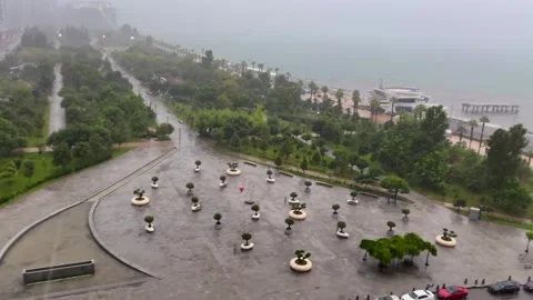 Heavy rain falling from elevated view over Batumi, covering city streets Stockbeeldmateriaal 346743066