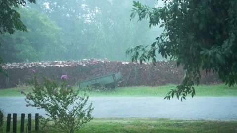 Heavy rain falling on an empty countryside little road Stock Footage 195301943