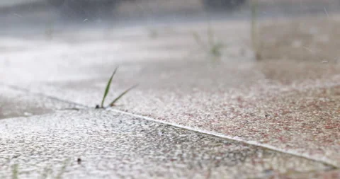 Heavy rain falling on the ground. raindrop crashing on the ground Stock Footage 339471038
