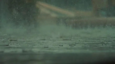 Heavy rain falling on the ground, water splashing and soaking the surface Stock Footage 324506358