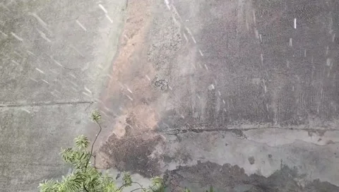 Heavy Rain Falling on Old Concrete with Plants – Urban Rain Scene Stock Footage 308817273