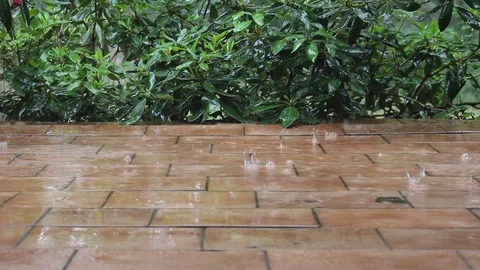 Heavy rain falling on old patio tiles Stock Footage 92297803