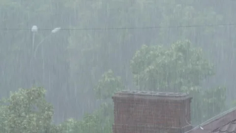Heavy rain falling over urban rooftops, 8K with authentic natural sound Stock Footage 336727609