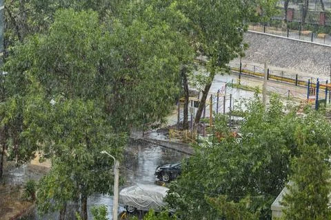 Heavy Rain Falling Over Urban Residential Neighborhood with Playground Stock Photos