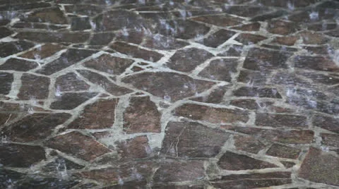 Heavy rain falling onto paving Stock Footage 26630982
