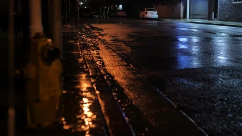 Heavy rain falling to road. Light reflecting on the asphalt. Empty street Stock Footage 264773137