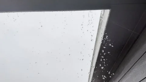 Heavy Rain Falling From Roof Edge and Gutter Video stock 344779368
