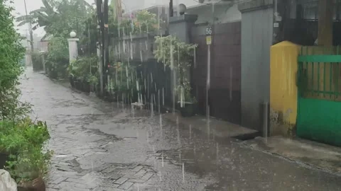 Heavy Rain Falling on Street with Wet Surface Stock Footage 332899707