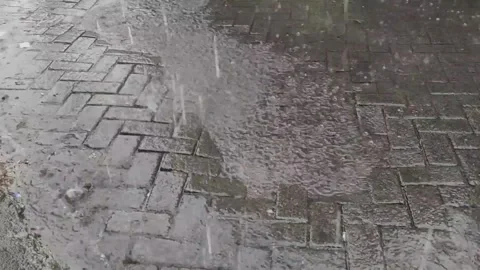 Heavy Rain Falling on Street with Wet Surface Stock Footage 332899737
