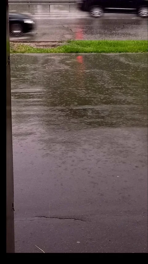 Heavy Rain Falling on Wet Asphalt with Passing Cars, Vertical Background Footage Stock Footage 342449245