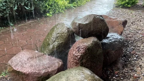 Heavy Rain Falling on Wet Decorative Garden Stones Stock Footage 344799052
