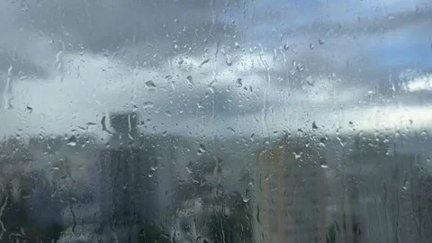 Heavy Rain Falling on a Window Glass Stock Footage 345996262