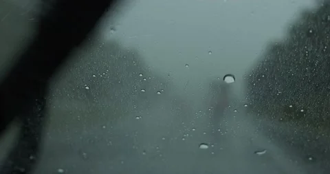Heavy rain falling on a windshield Stock Footage 229716612