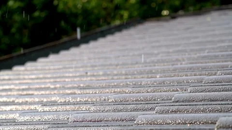 Heavy rain falls after a storm passes over a rooftop in Europe, during the day Stock-Footage 336571547