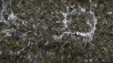 Heavy rain falls on the ground, close-up. Slow motion Stock Footage 157897042
