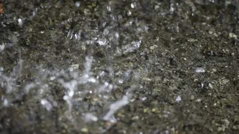 Heavy rain falls on the ground, close-up.  Slow motion Stock Footage 157948533