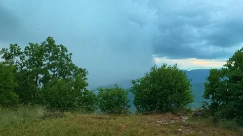 Heavy rain falls over green trees. Kozji Kamen viewpoint, Serbia 스톡 동영상 341875821