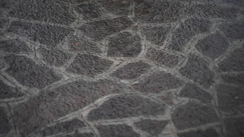 Heavy rain falls on a stone pavement during a violent thunderstorm Stock Footage 154136070